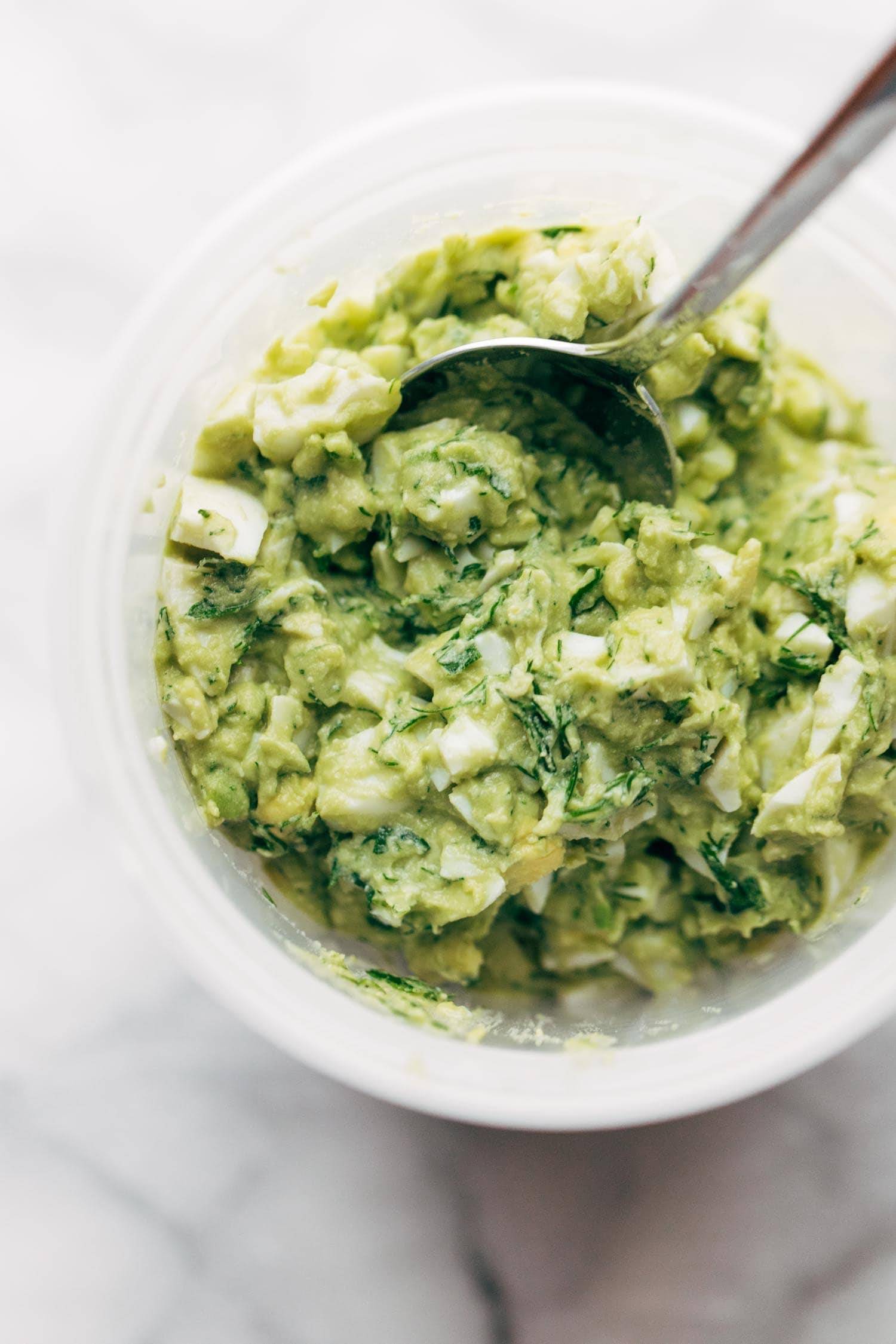 Avocado Egg Salad in a bowl with a spoon.