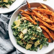 Avocado Kale Caesar Salad with sweet potato fried on plate.