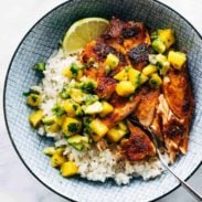 BBQ salmon in a bowl with mango salsa and rice.