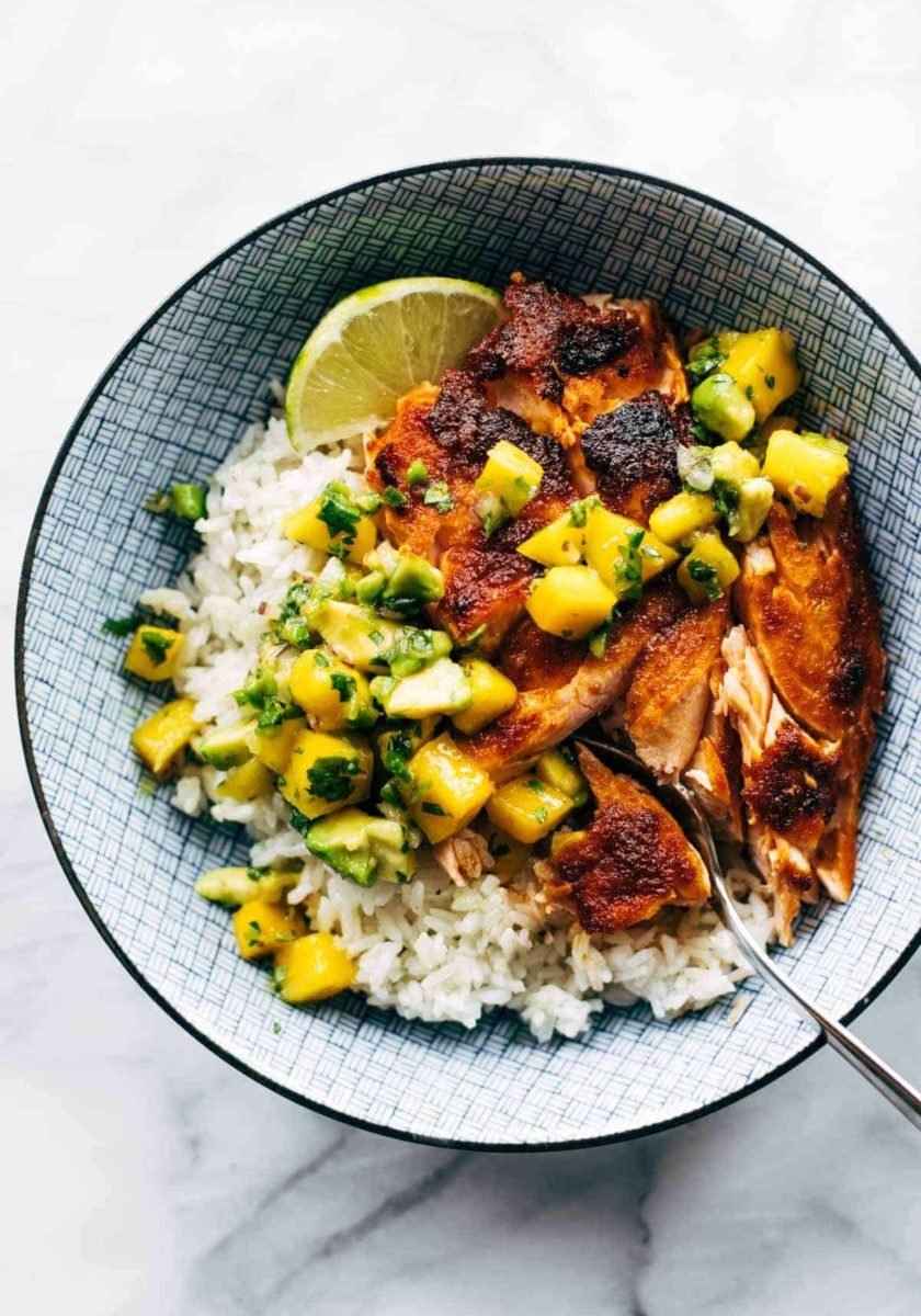 BBQ salmon in a bowl with mango salsa and rice.