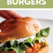 Buffalo chicken burgers on a bun with lettuce and whipped feta spread.