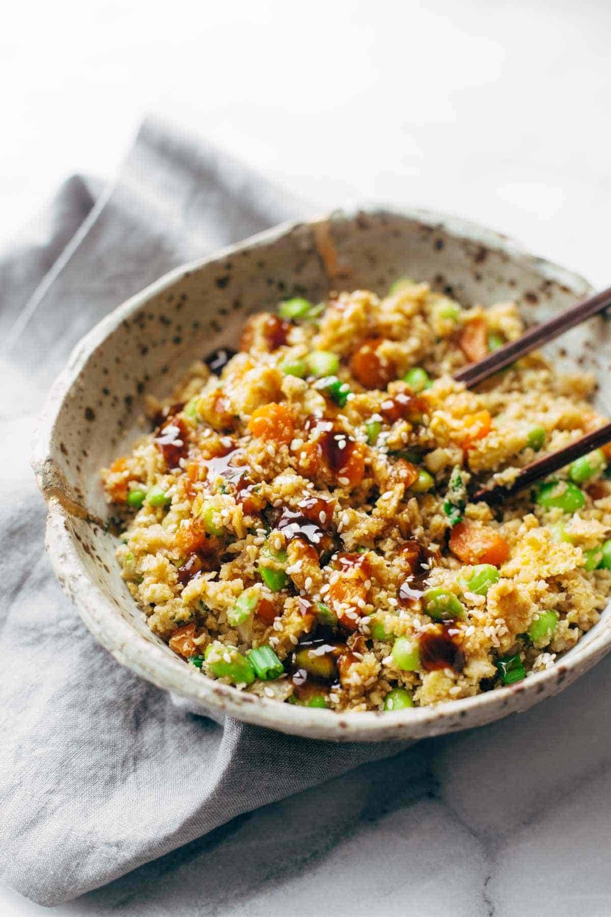 cauliflower fried rice in a bowl with chopsticks