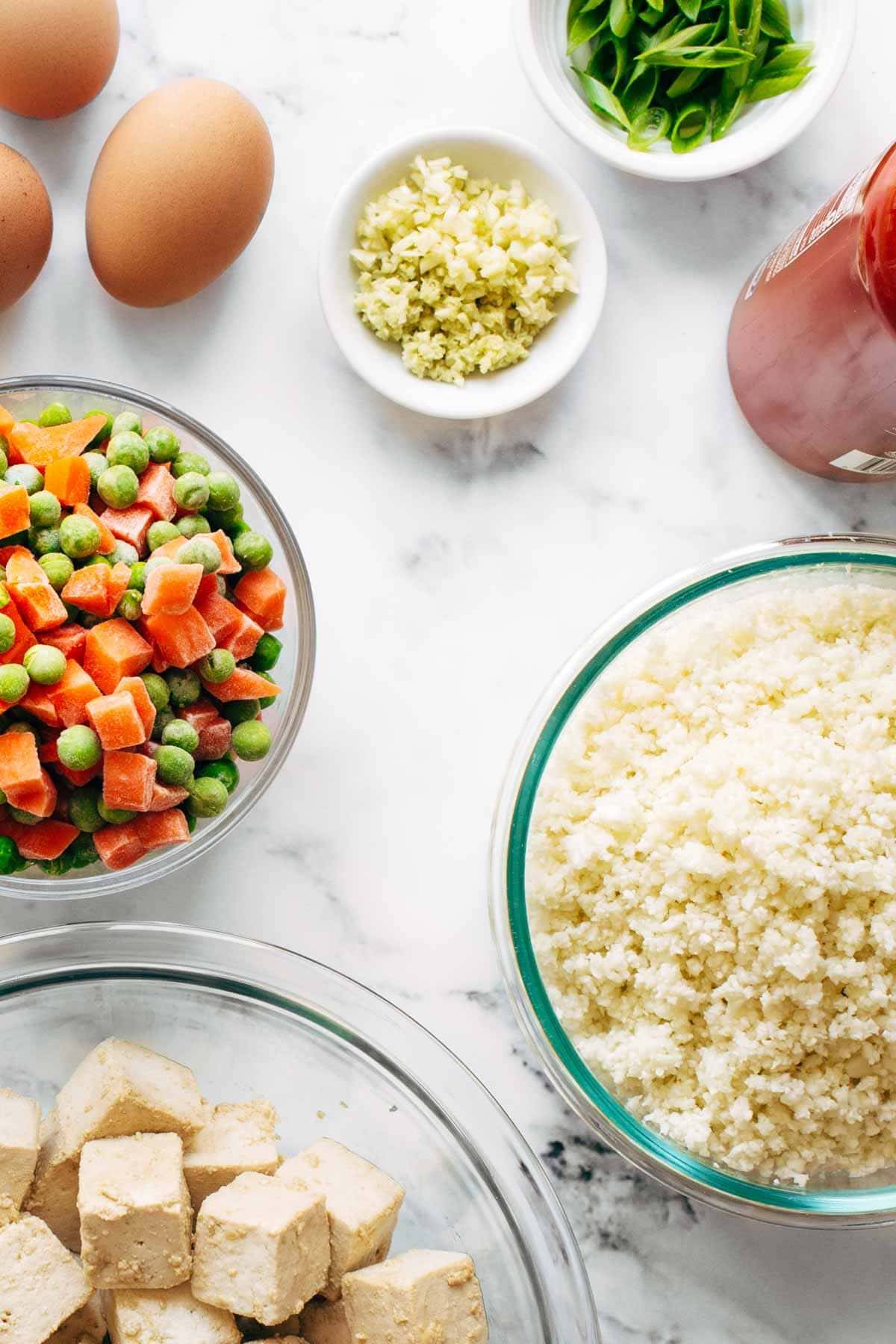 Ingredients in bowls for cauliflower fried rice.