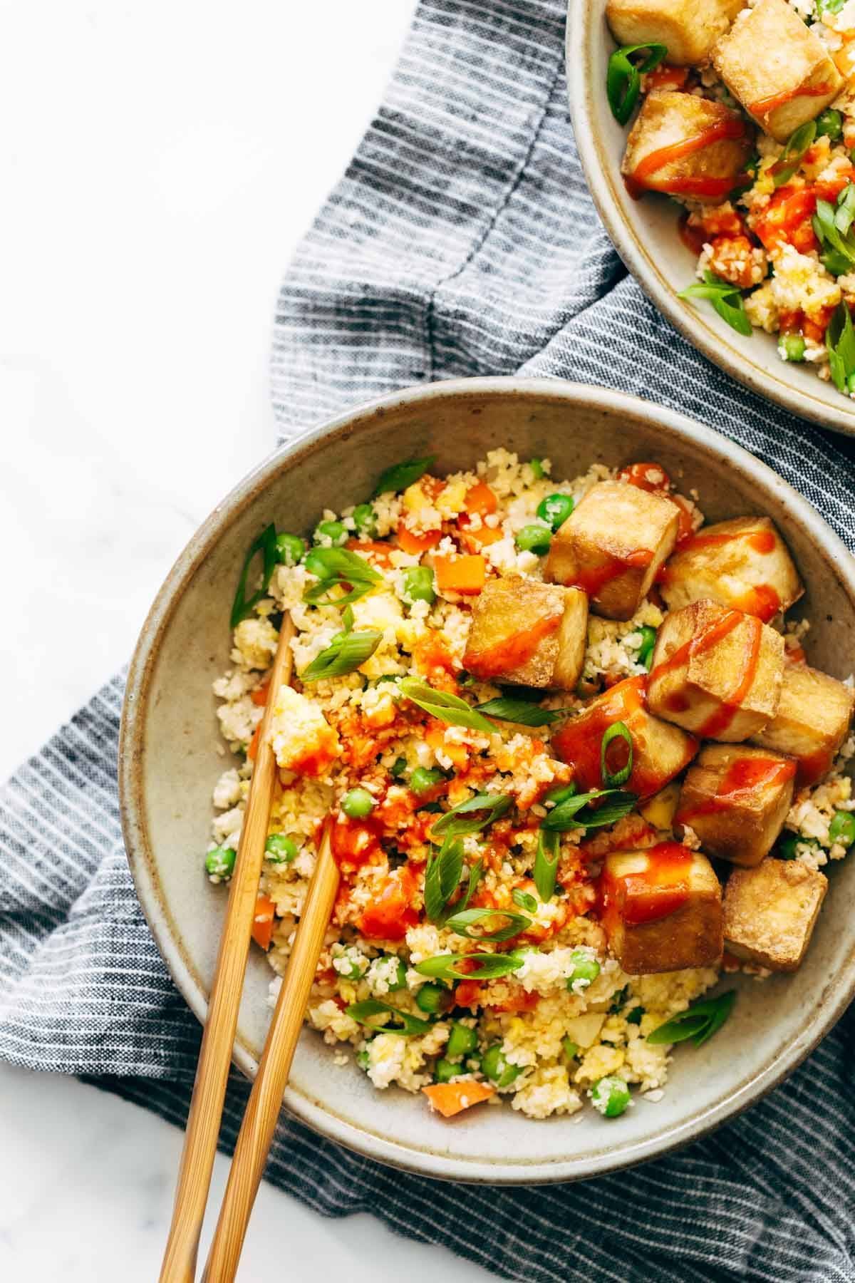 Cauliflower fried rice on a bowl with tofu.