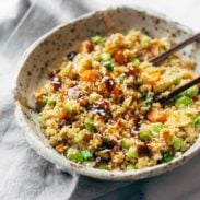 Cauliflower fried rice in a bowl with chopsticks.