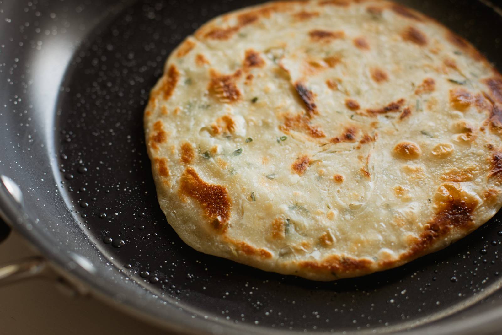 Scallion pancake in a pan.