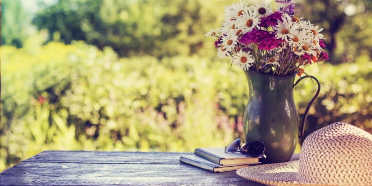 Flowers and vase on a table in the countryside