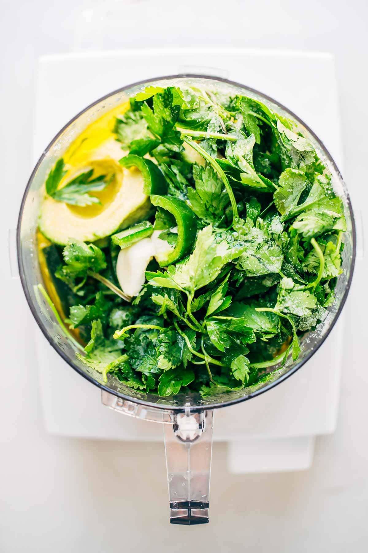 Ingredients for Magic Green Sauce in a food processor. 