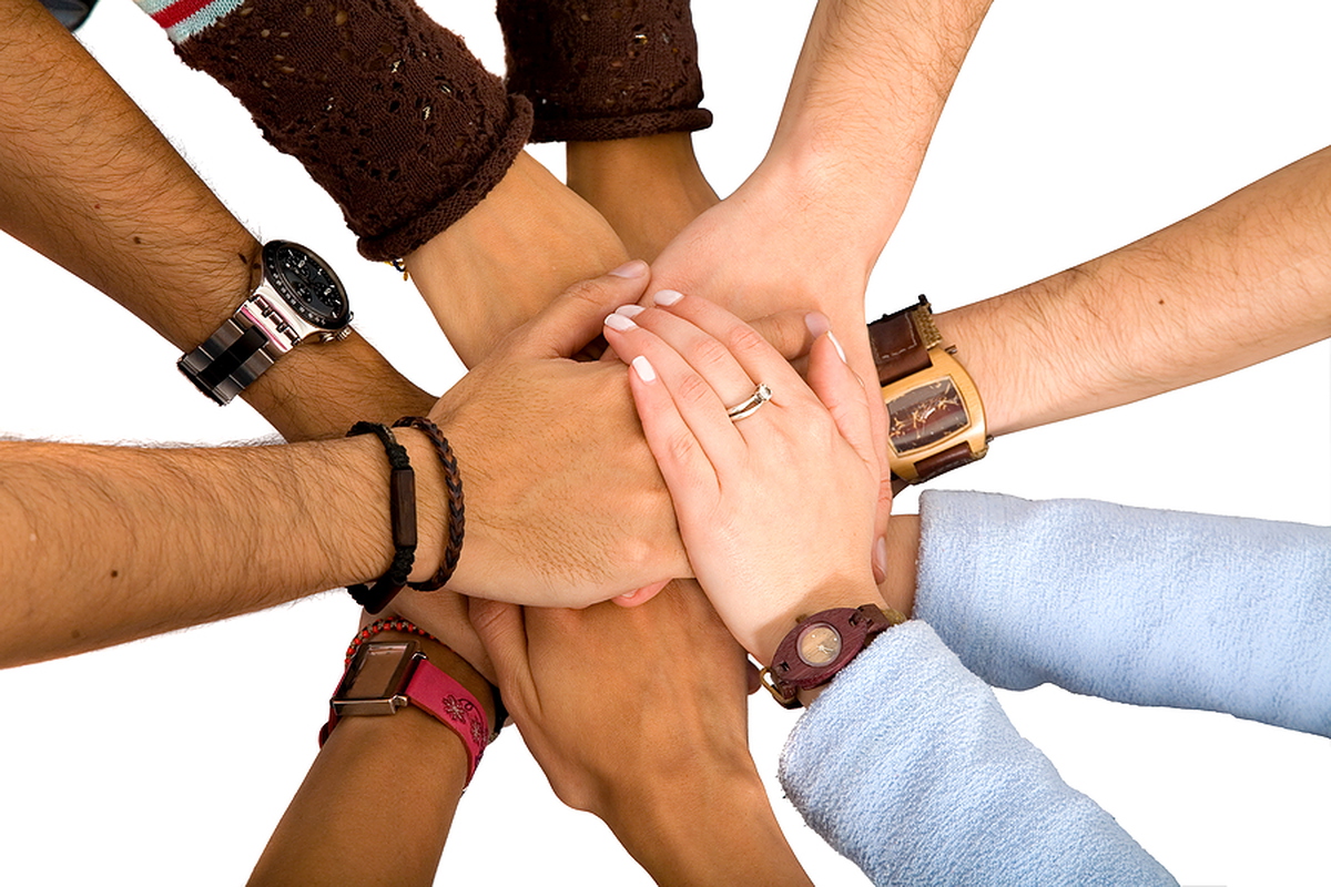 Group of people joining hands