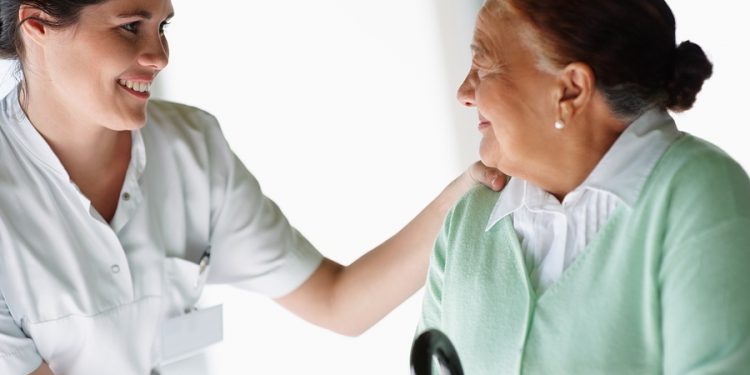 Nurse assisting an elderly lady