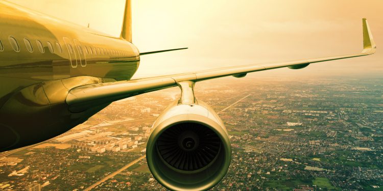 A passenger plane flying over a city