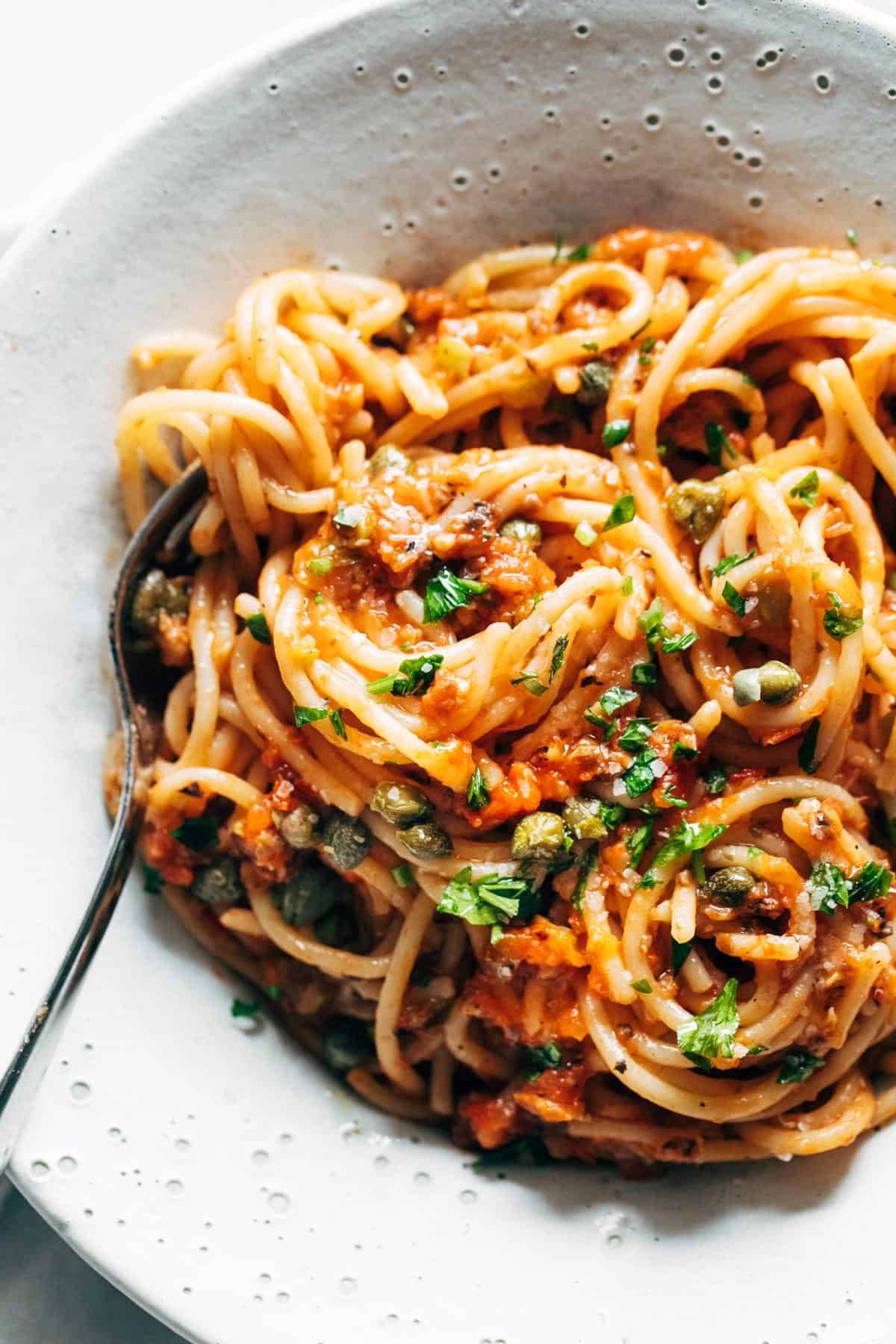 Roasted tomato puttanesca in a bowl.