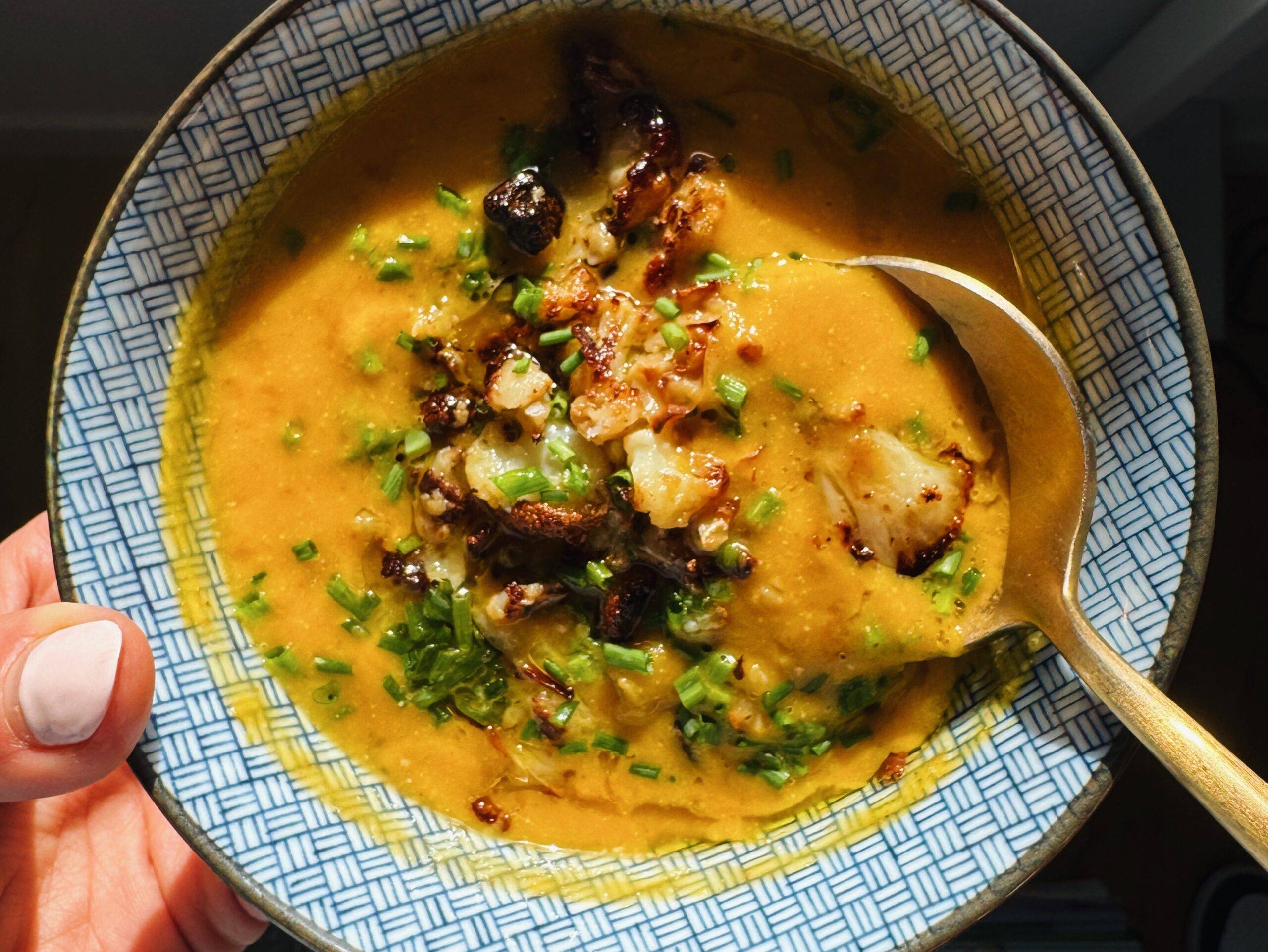 Sweet potato soup in a bowl topped with cauliflower.