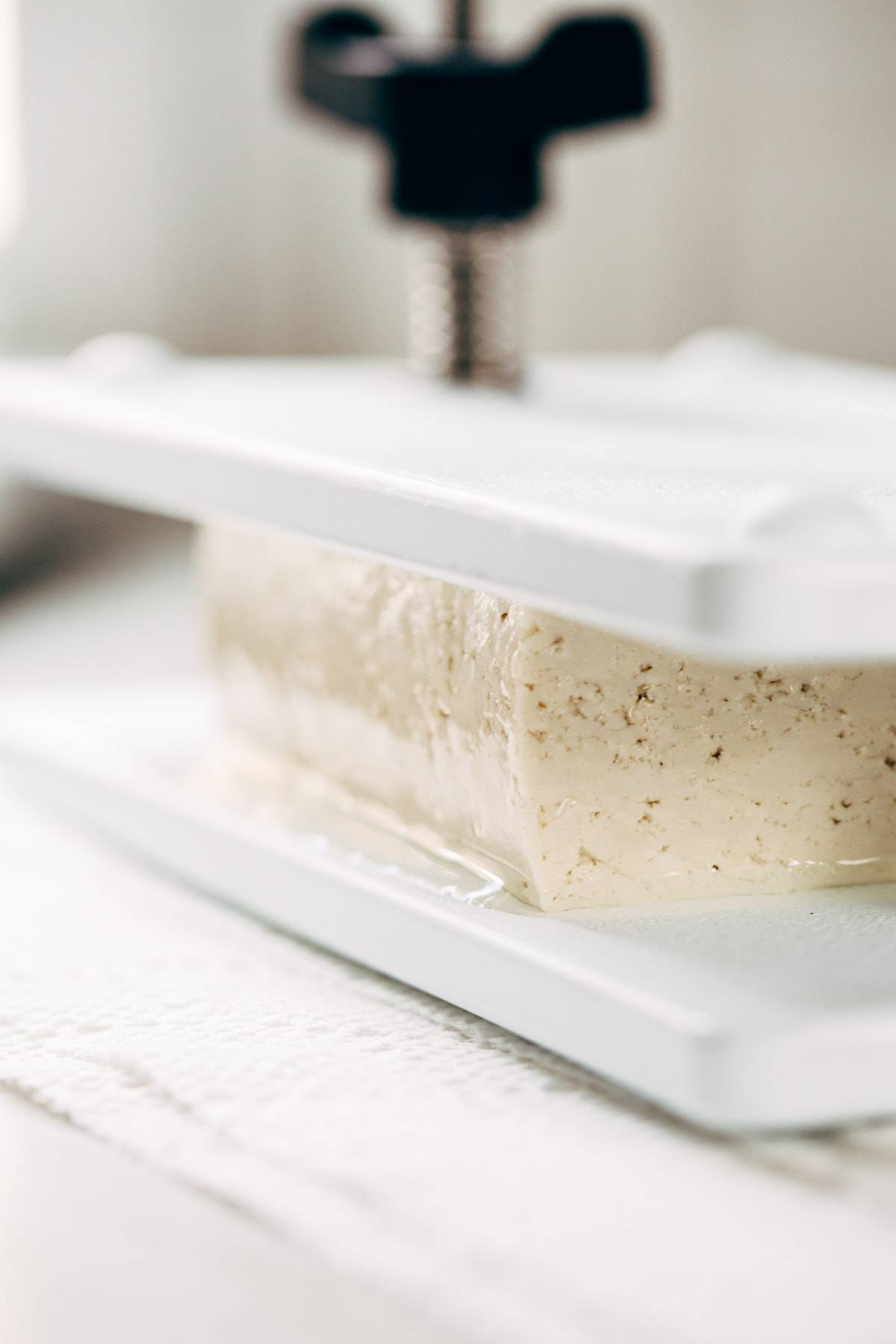 Tofu pressed in tofu press.