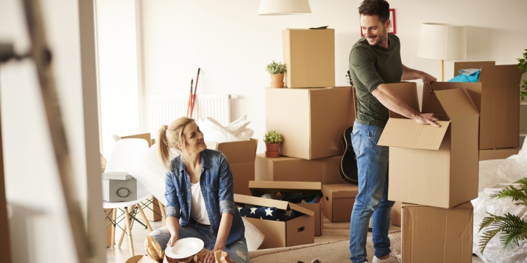 Couple unpacking boxes in a new home