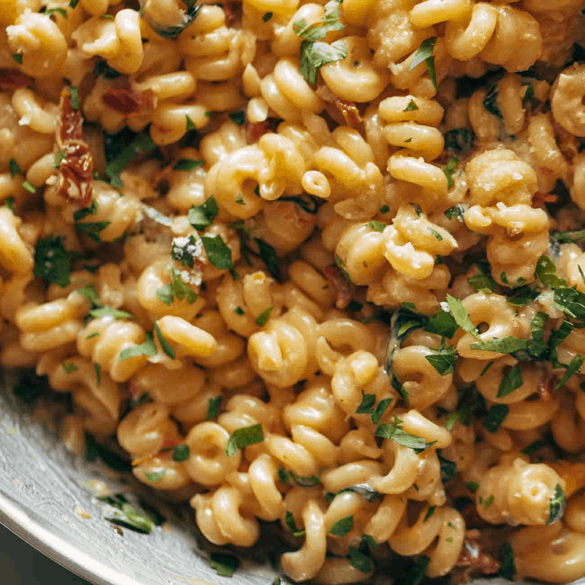 A pot of creamy garlic sun-dried tomato pasta.