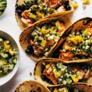 Salmon tacos with cucumber salsa lined up.